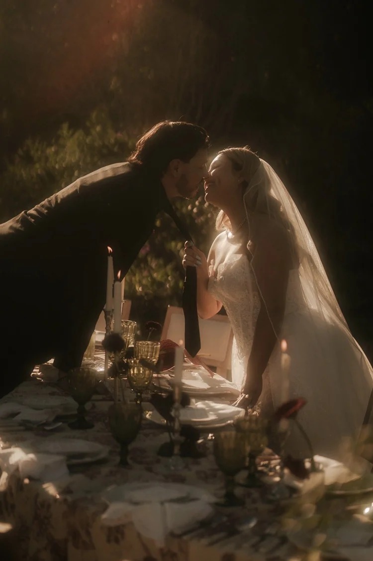 Bride and groom at candlelit dinner