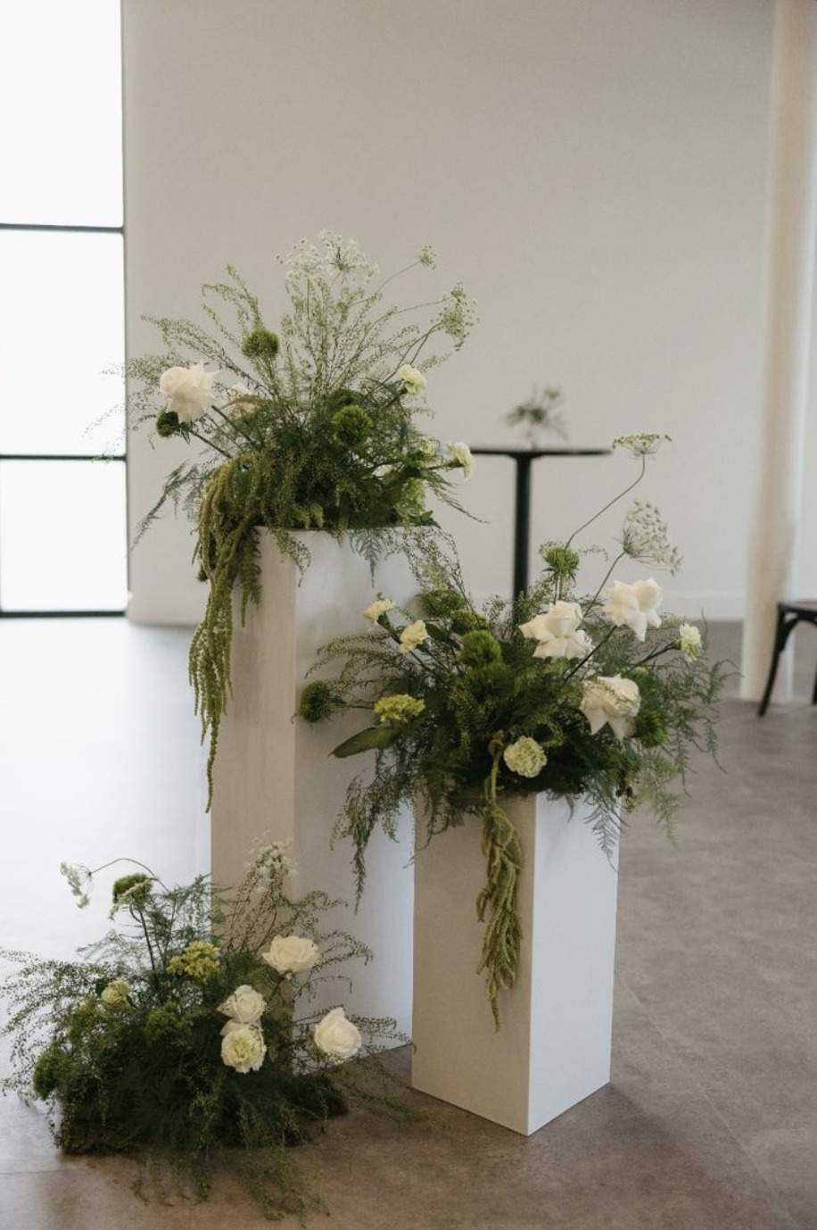 White floral riser plinths in graduated heights