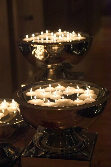 Silver footed bowls with floating candles